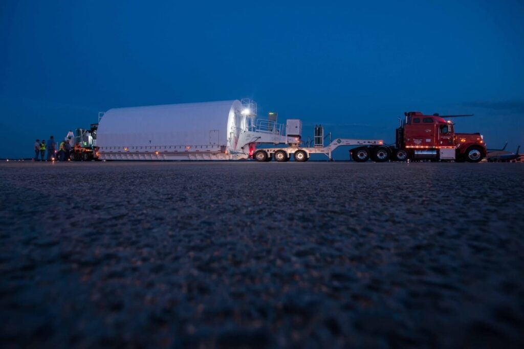 Semi-truck hauling oversized load on road