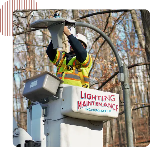 Worker repairing street light